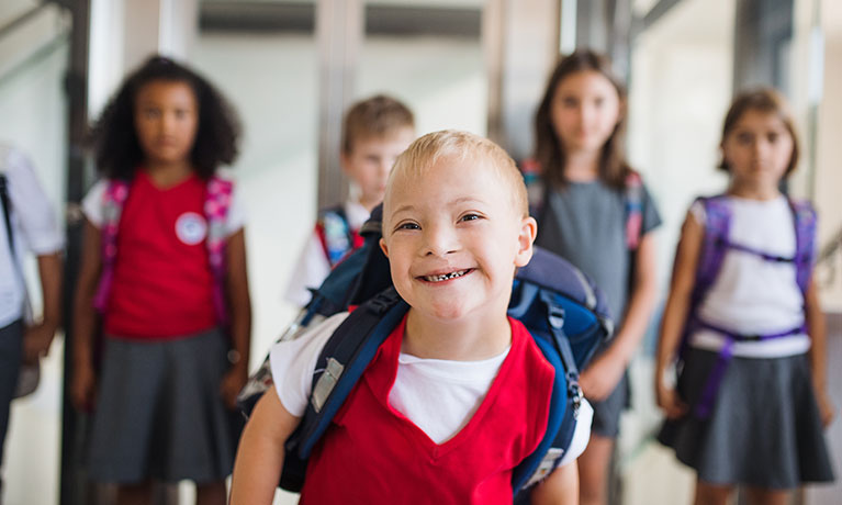 Children in uniform walking in a hallway