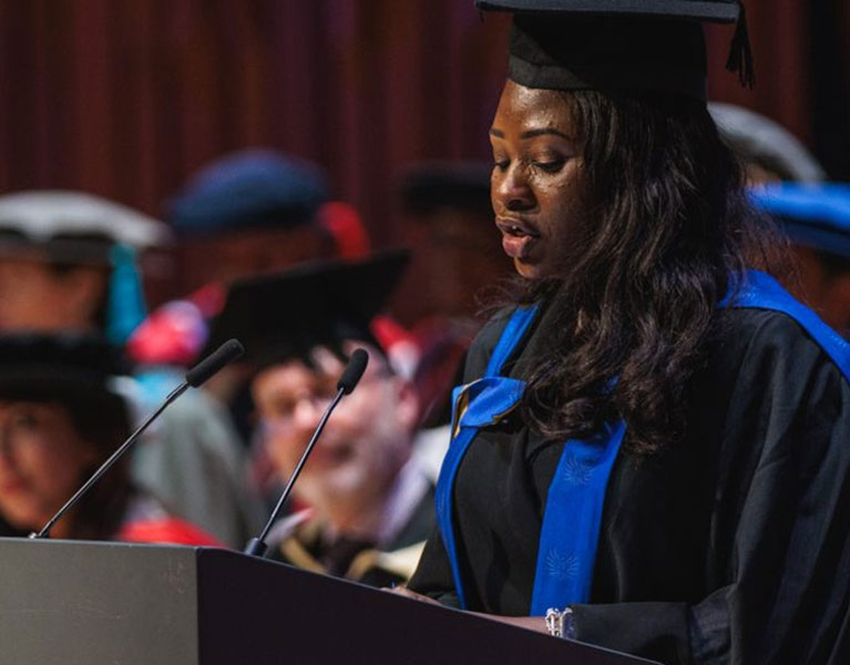 Graduation student speaking to audience from a podium