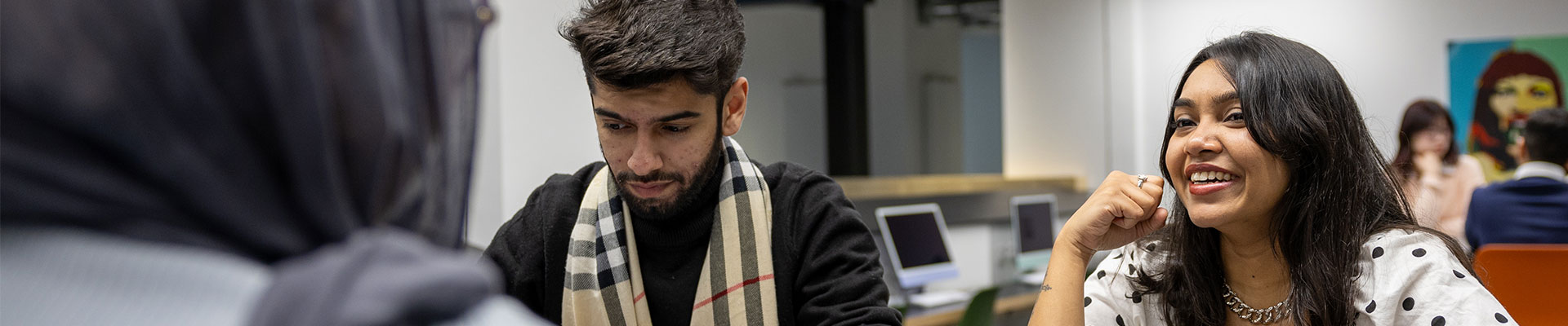Students sitting together in a studio