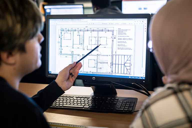 architecture students looking over project designs