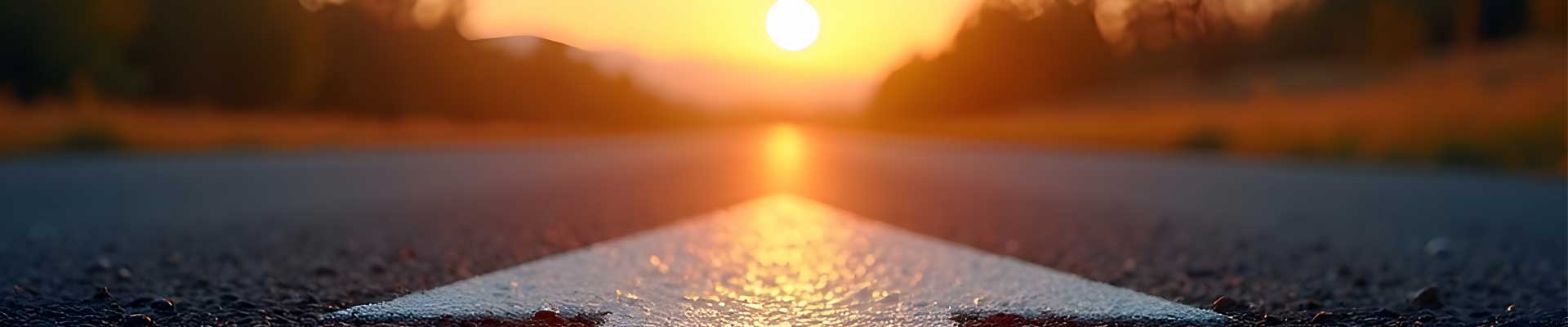 road at sunset with an arrow pointing forward