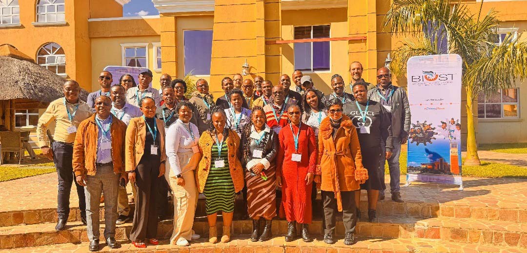 A group of people gathered outside a brick building in Palapye, Botswana