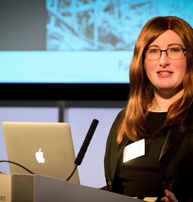 Bianca Wright speaking in a microphone at a conference