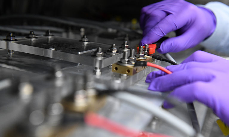 close up of hands working on machinery