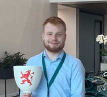 Ali Haddow holding a trophy cup