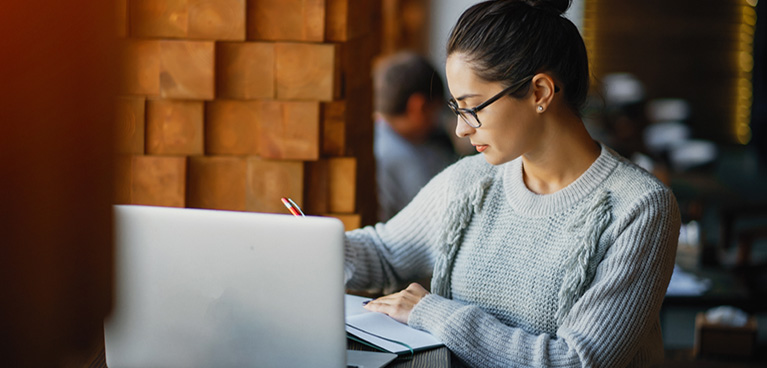 someone studying on their laptop in a public space