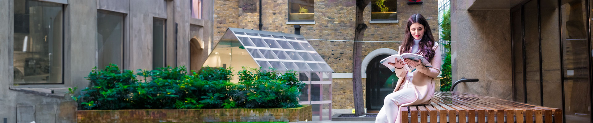 Woman sitting on a bench reading