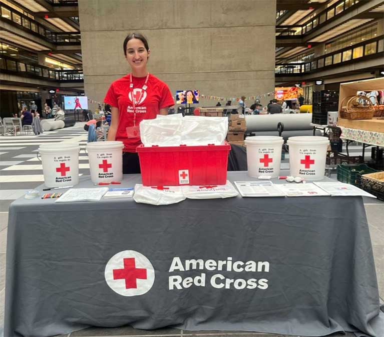 Leila Grebby standing at the American Red Cross stand