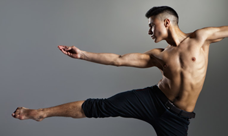 Male dancer standing on one leg