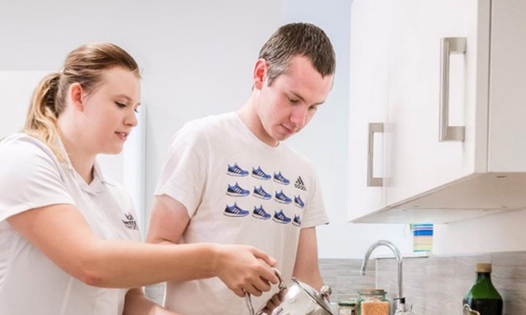 Two nursing students working in a medical room