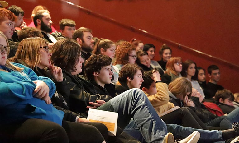 College students listening to talk in theatre