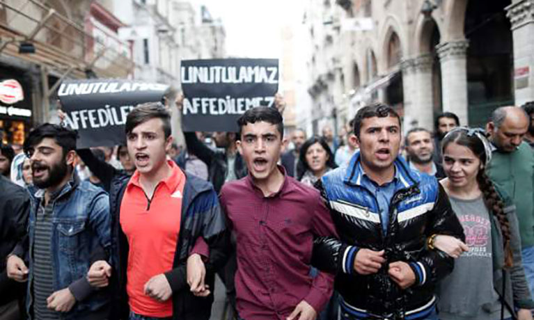 young males protesting arms in arms