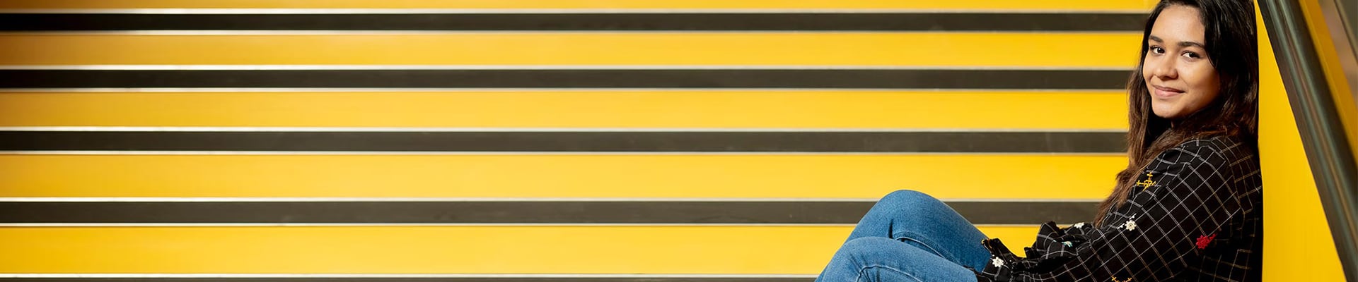 girl sitting on the stairs of the hub building