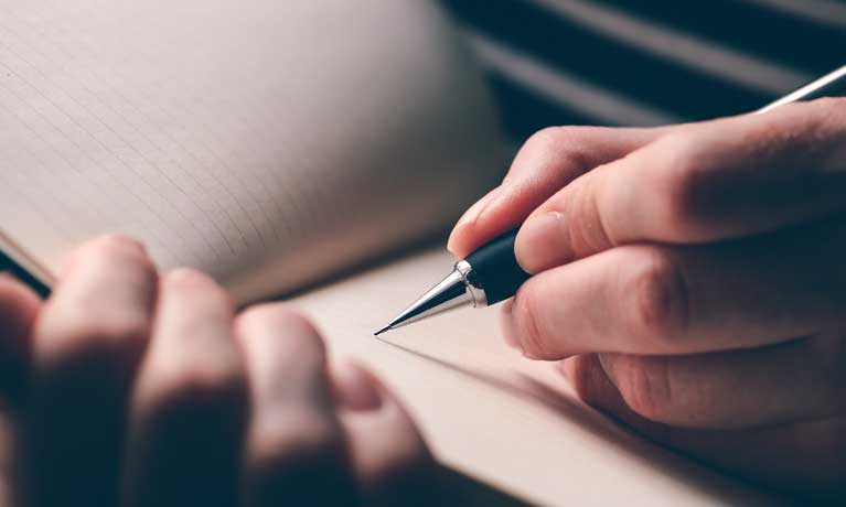 close up of a hand writing 