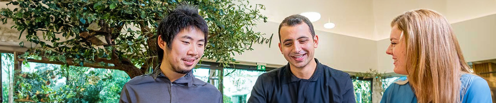 2 men and a woman sitting together in a social space