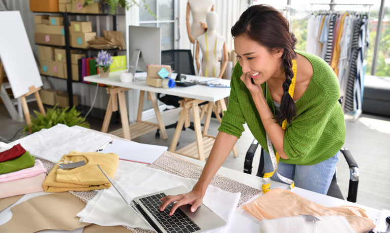 Young Asian woman entrepreneur  fashion designer working in studio