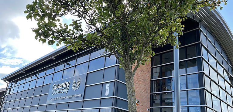 Exterior of the Centre for Trust, Peace and Social Relations building with a tree at the corner of the building