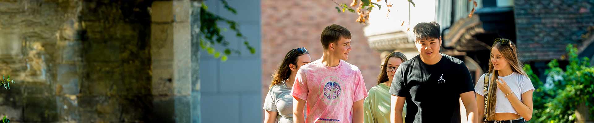 Students walking together in front of a university building