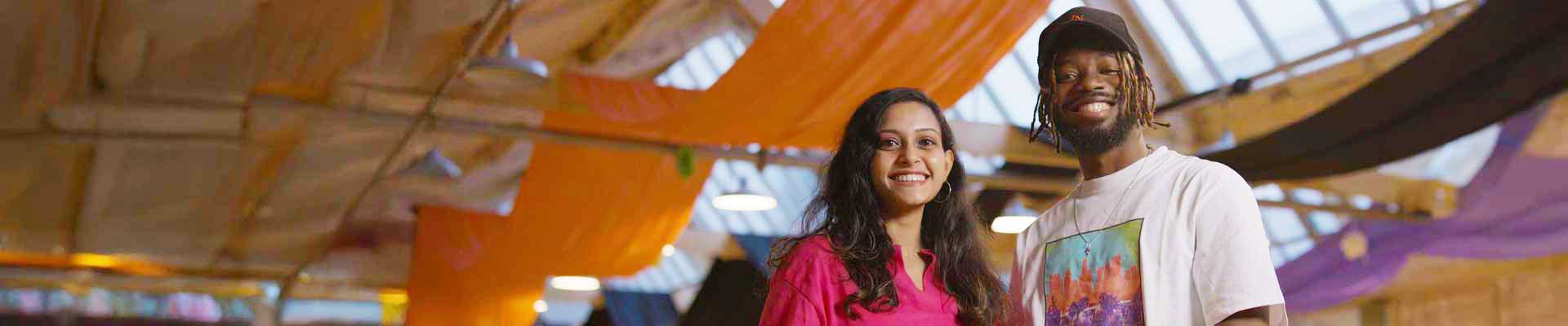 Smiling couple in a large conference area