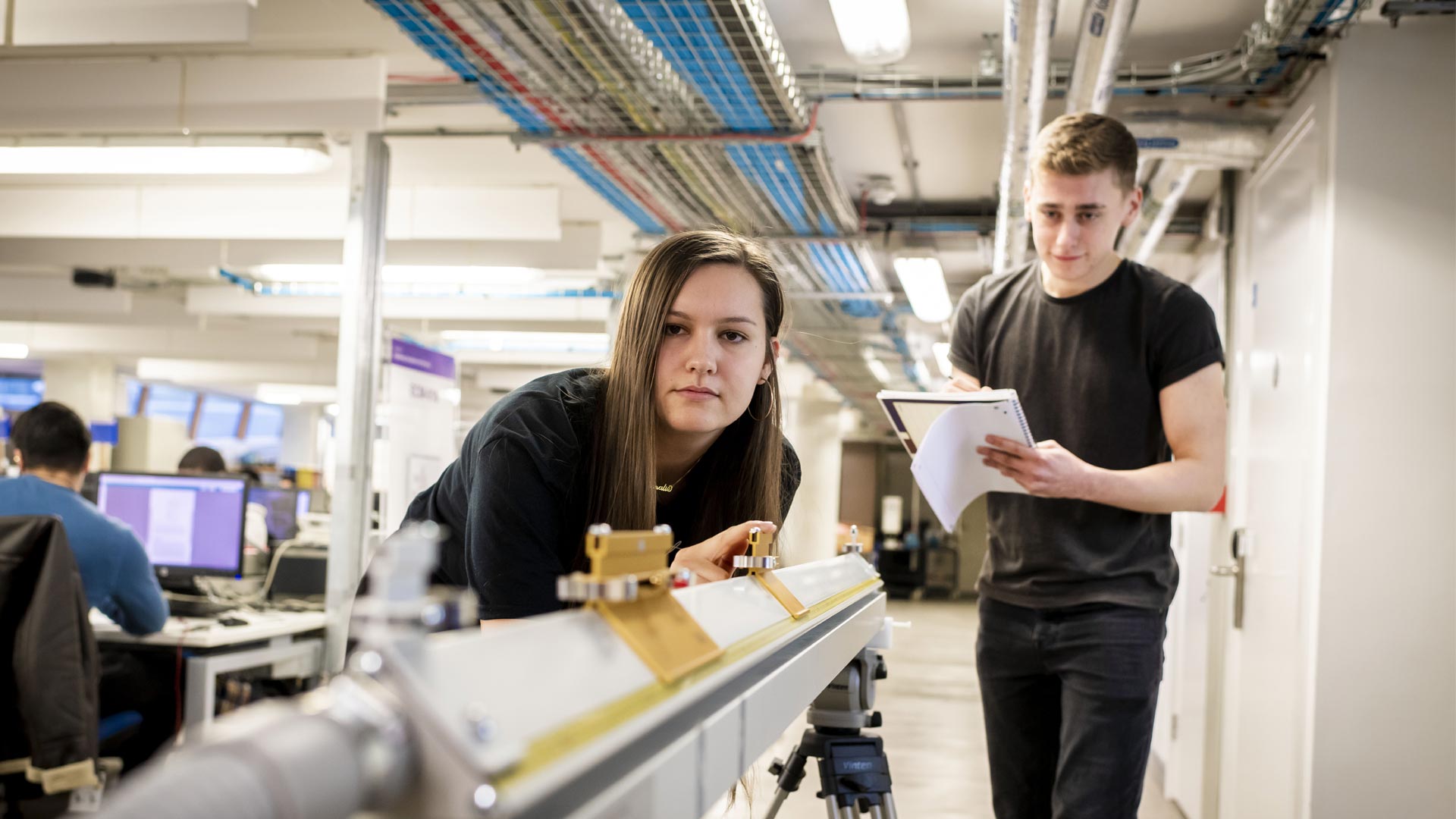 Two students using equipment in the lab