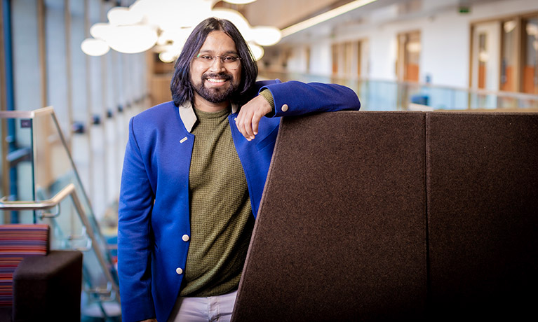 Chetak Nangare leaning against a seat