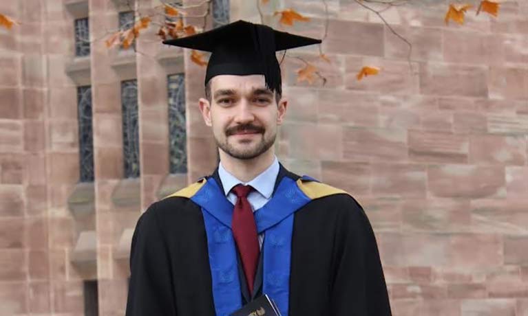 head shot of Sebastian in graduation gown and hat 