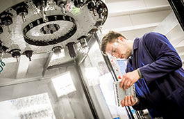 A student working on an engine part.