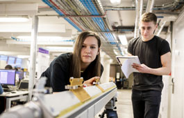 Two students using equipment in the lab