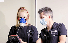 Student using breathing monitor while using an exercise bike