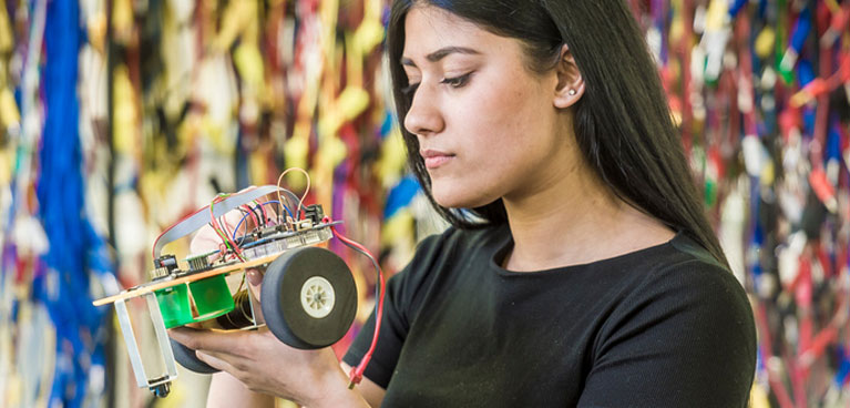 female holding an electronic device