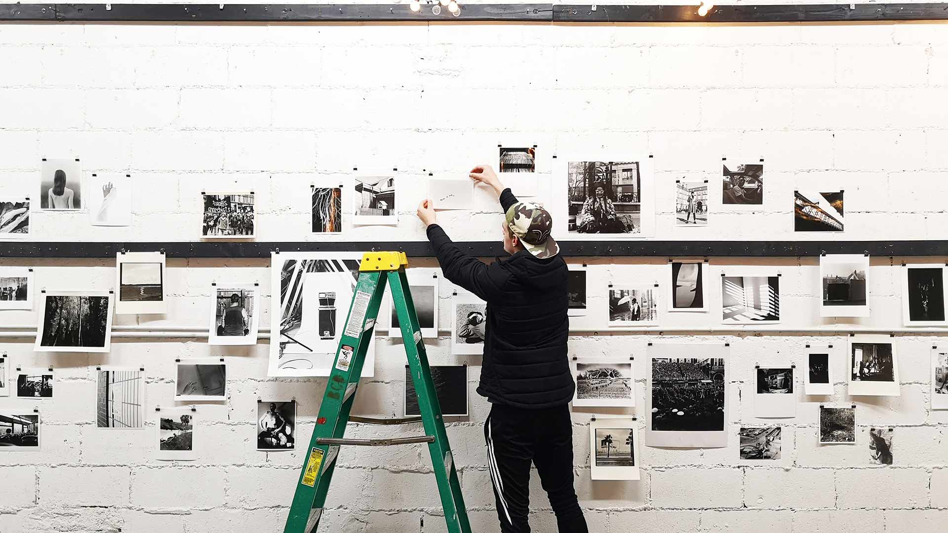 Photography studio with a white background, coloured lights and equipment around