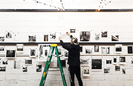 Photography studio with a white background, coloured lights and equipment around