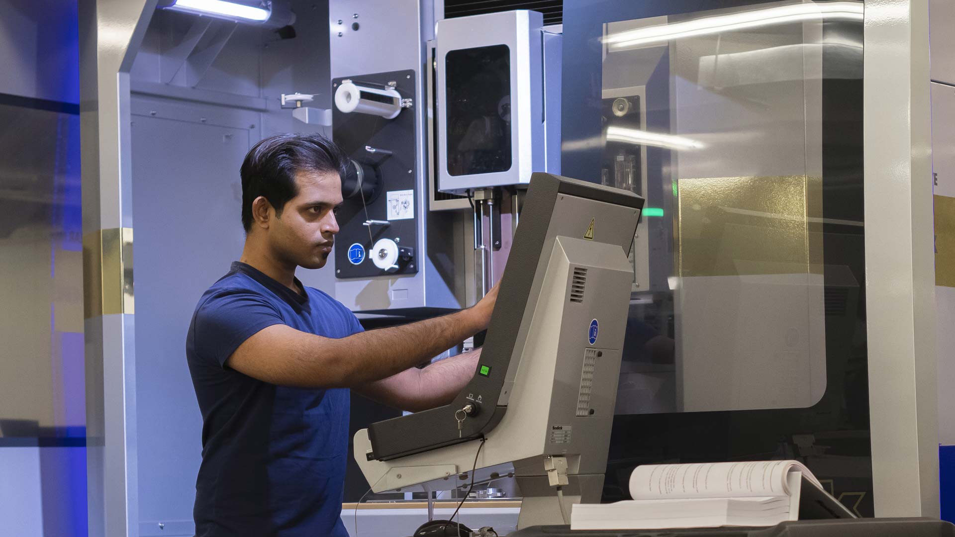 student using engineering lab machinery