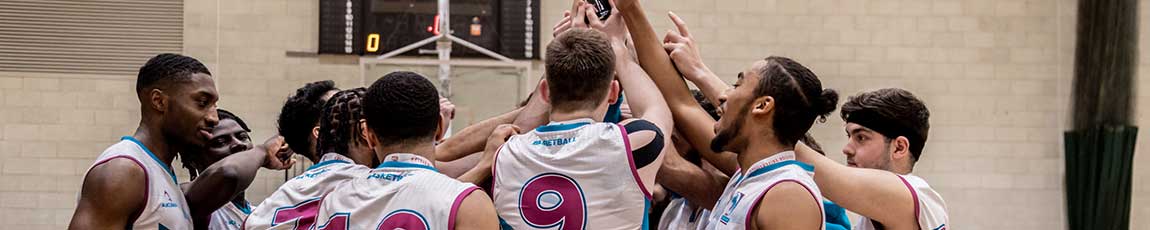 men's basketball team celebrating a win