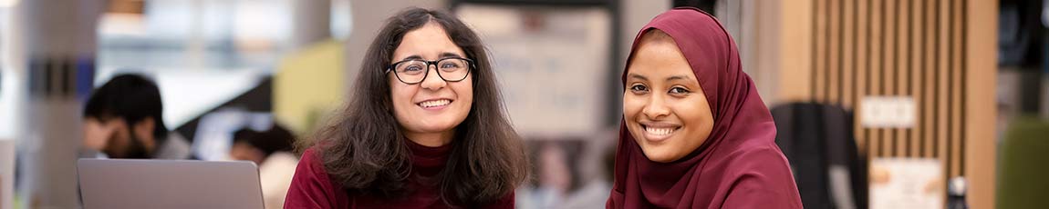 Two students smiling face on