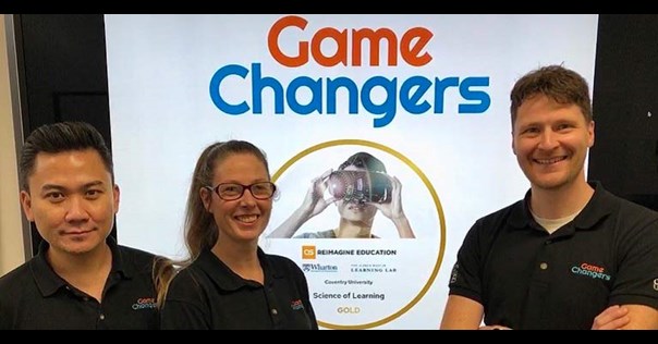 Three members of University staff in front of Gamechangers logo.