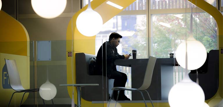 student sitting in a pod