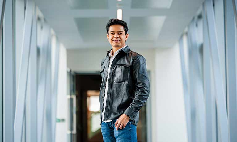 PG student Nishant Raval standing  in a corridor 