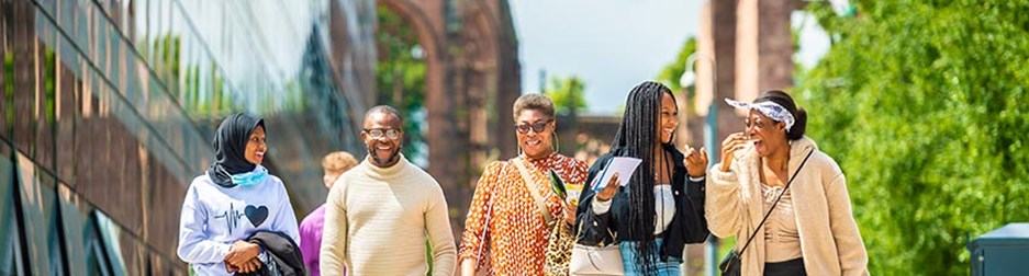 Group of people walking on a sunny day close to Coventry Cathedral