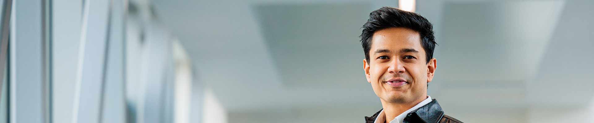 Student arranging postit notes on a perspex screen