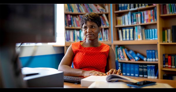 Female student at desk using computer 