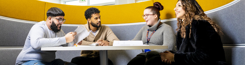 Four students chatting in a study booth at the CU Coventry campus