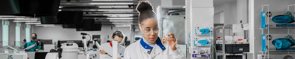 student scientist looking at a test tube