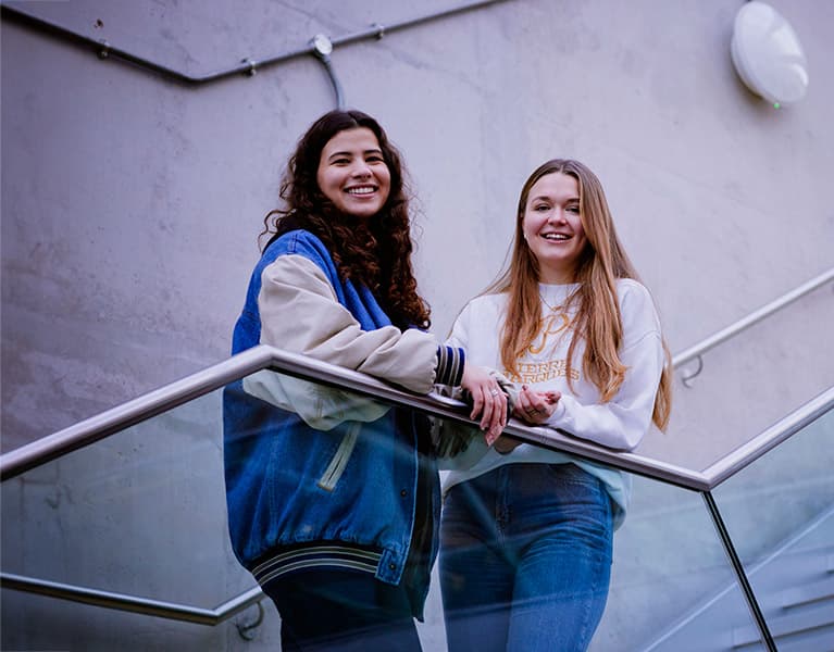 Student posing for a photo outside of a university building
