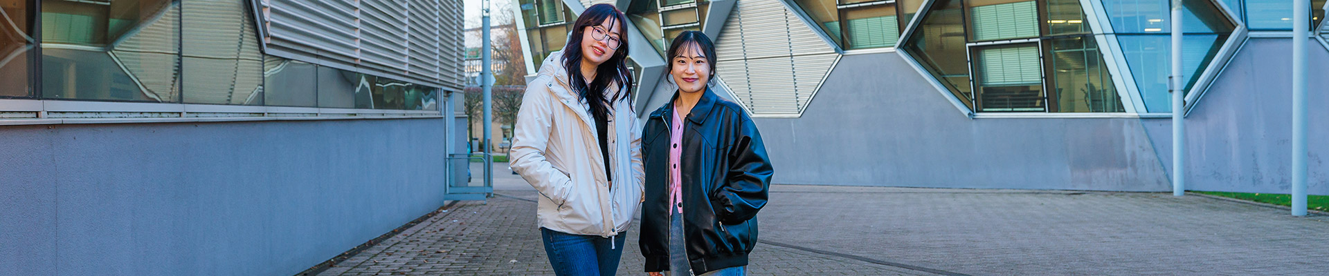 Two students stood outside of Sir Frank Whittle smiling
