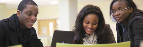 Three postgraduate students at a desk