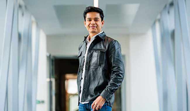 Nishant Raval postgraduate student standing in a corridor