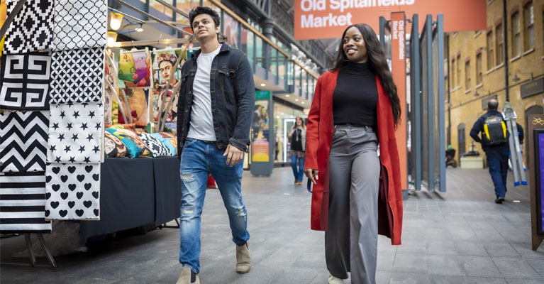 Man and woman walking on a london street