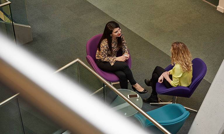 Two ladies sat down talking