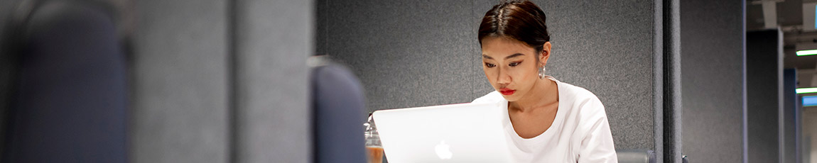 Student sat working on a laptop